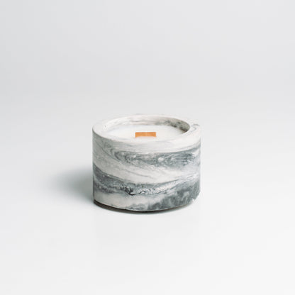 Marble-patterned candle on a light gray background